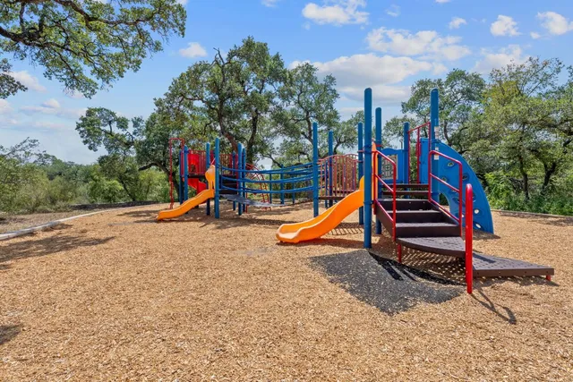 a view of a park with swings and slides