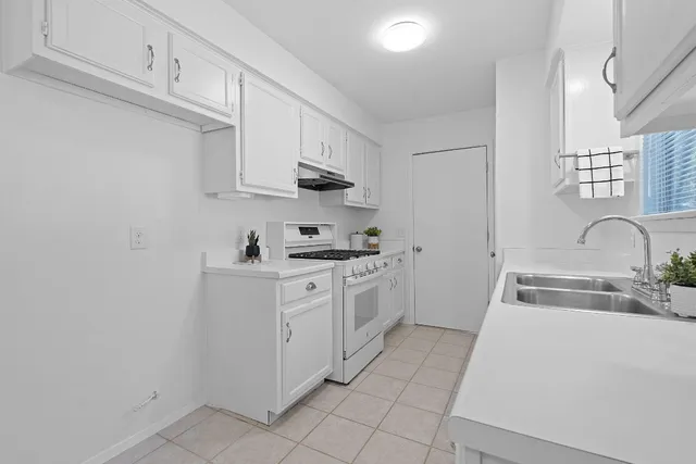 a kitchen with stainless steel appliances granite countertop a sink and cabinets