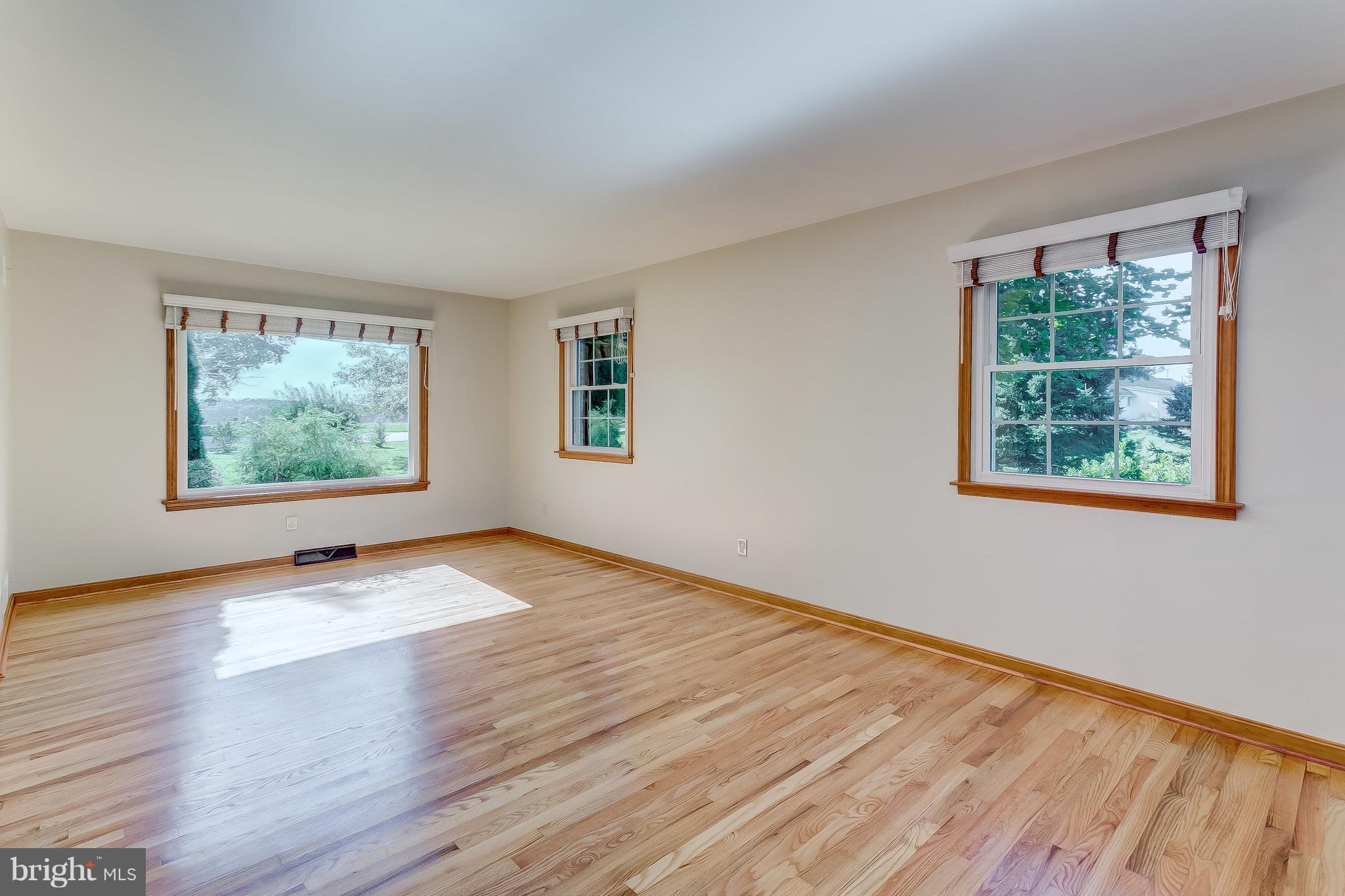 3200 Troyer Road White Hall, MD 21161 - Photo 19 of 36 a view of an empty room with wooden floor and windows