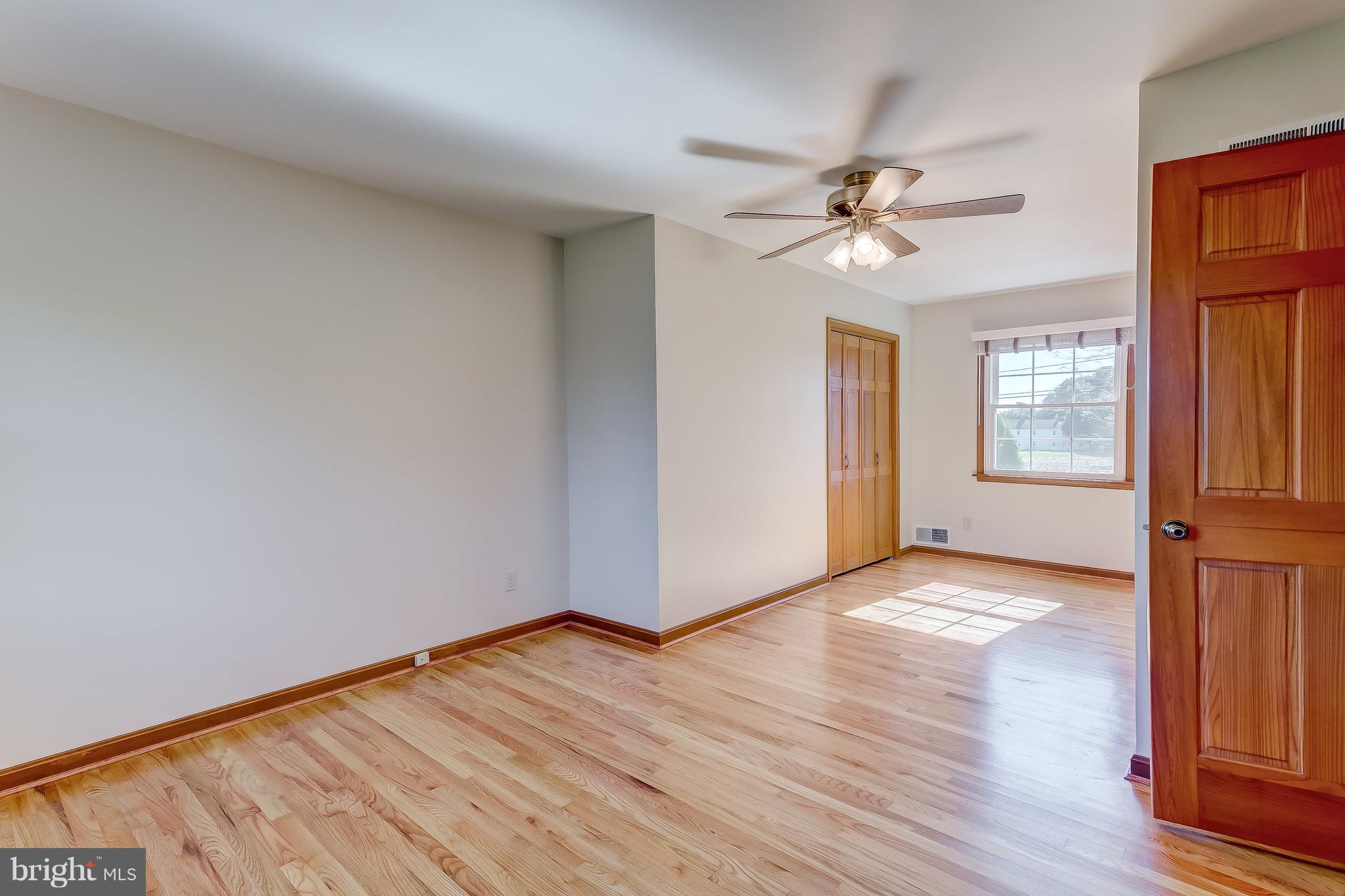 3200 Troyer Road White Hall, MD 21161 - Photo 21 of 36 a view of a livingroom with wooden floor and a ceiling fan