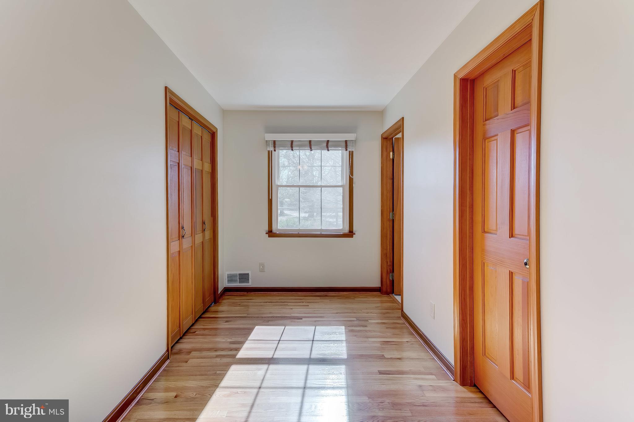 3200 Troyer Road White Hall, MD 21161 - Photo 22 of 36 a view of a hallway with wooden floor and windows