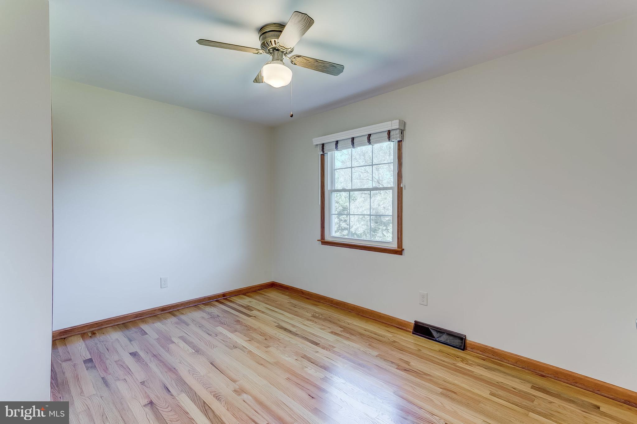 3200 Troyer Road White Hall, MD 21161 - Photo 28 of 36 an empty room with wooden floor fan and windows