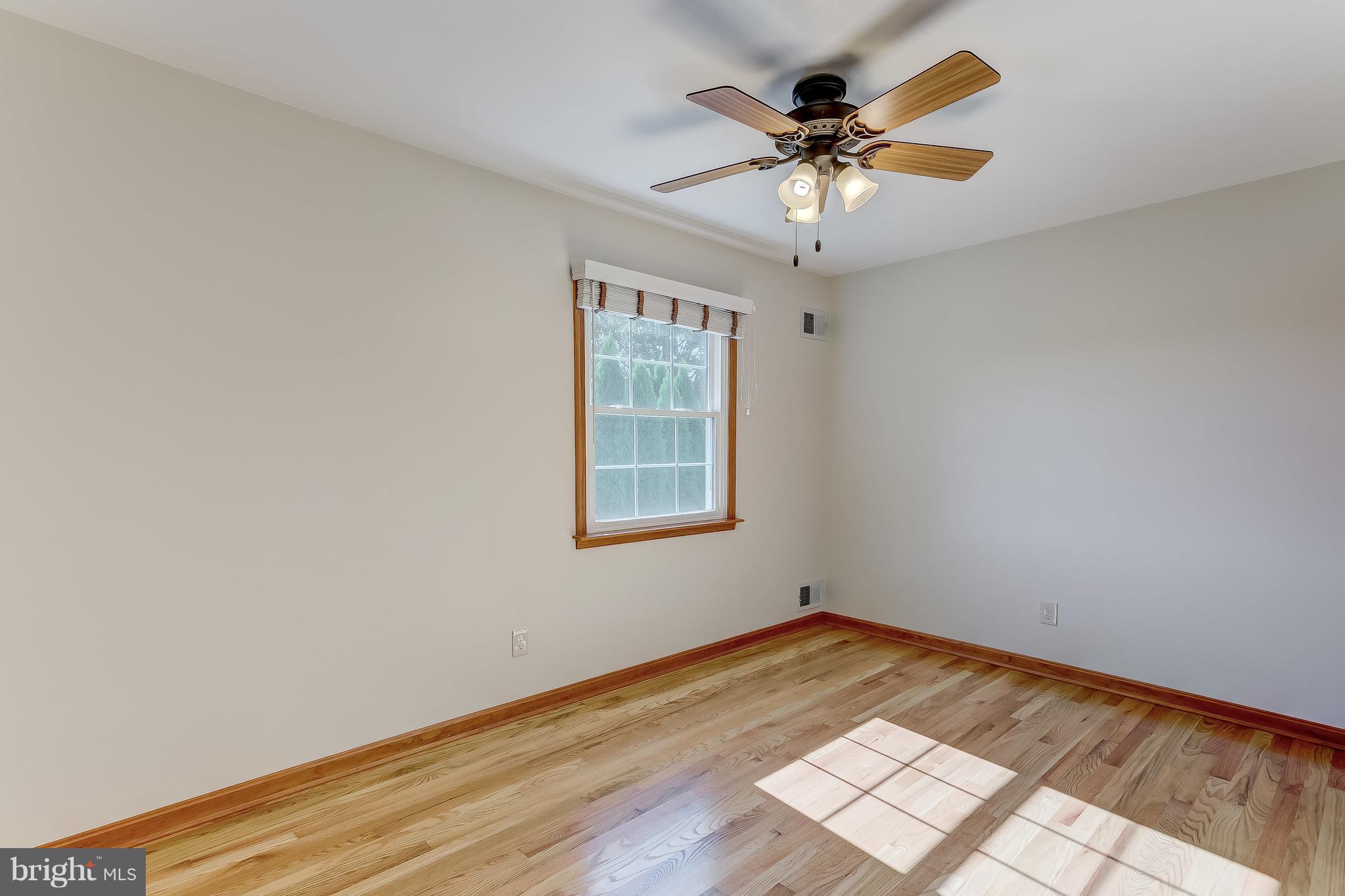 3200 Troyer Road White Hall, MD 21161 - Photo 31 of 36 an empty room with wooden floor and ceiling fan