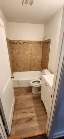a bathroom with a toilet and a tub
