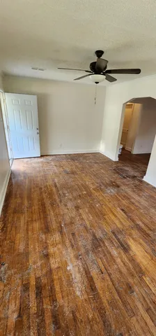a view of a room with wooden floor