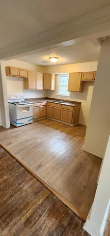a view of kitchen and wooden floor