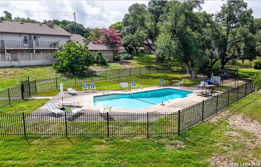 62 Oak Villa Road, Unit F2 Canyon Lake, TX 78133 - Photo 19 of 19 an aerial view of a house with swimming pool and a yard