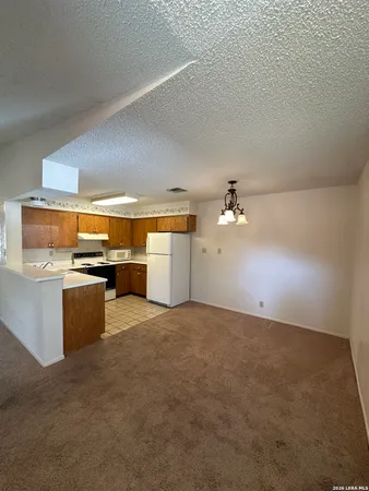 a view of empty room with a fireplace and fan