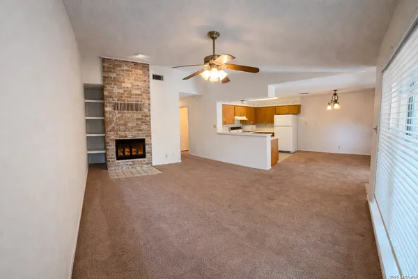 a kitchen with a refrigerator sink and wooden cabinets