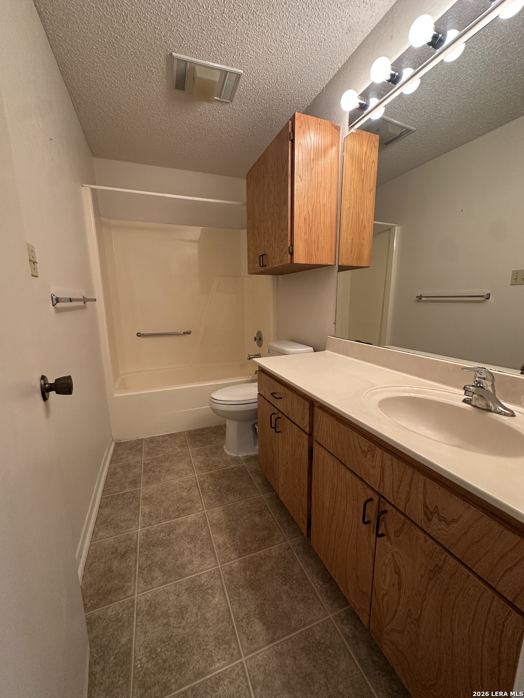 62 Oak Villa Road, Unit F2 Canyon Lake, TX 78133 - Photo 7 of 19 a bathroom with a sink a toilet and mirror