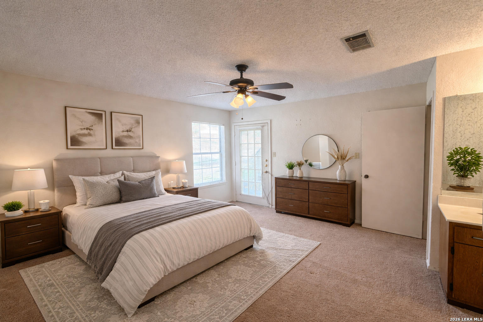 62 Oak Villa Road, Unit F2 Canyon Lake, TX 78133 - Photo 9 of 19 a bedroom with a bed and a chandelier