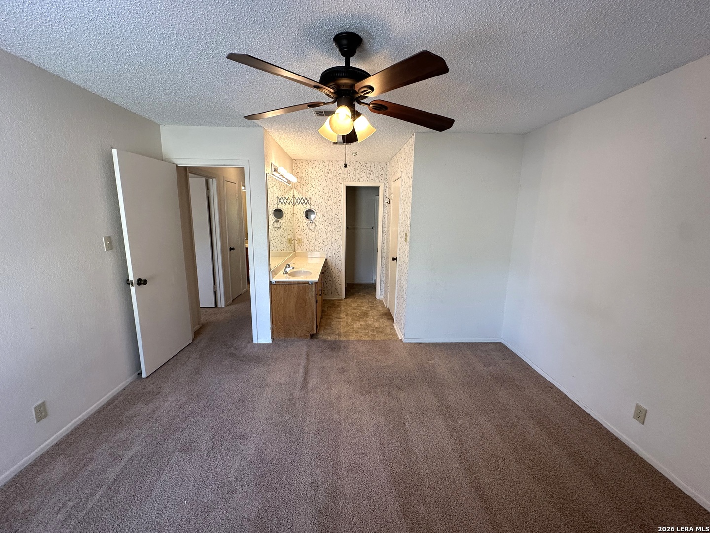 62 Oak Villa Road, Unit F2 Canyon Lake, TX 78133 - Photo 10 of 19 a view of a livingroom with wooden floor and a ceiling fan