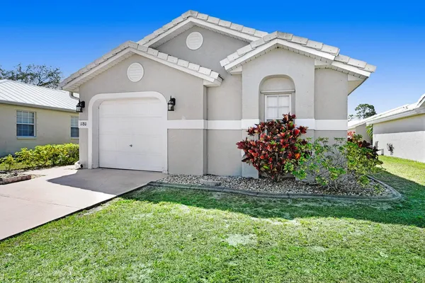 a front view of a house with a yard