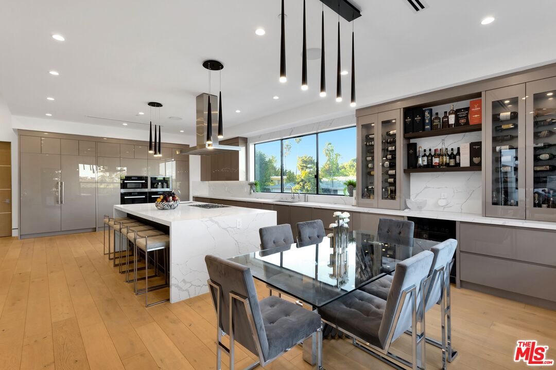 16366 Sloan Drive Los Angeles, CA 90049 - Photo 15 of 54 a dining room with furniture and wooden floor