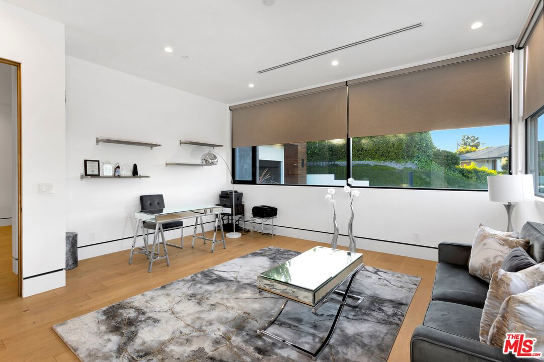 16366 Sloan Drive Los Angeles, CA 90049 - Photo 20 of 54 a living room with furniture and a flat screen tv