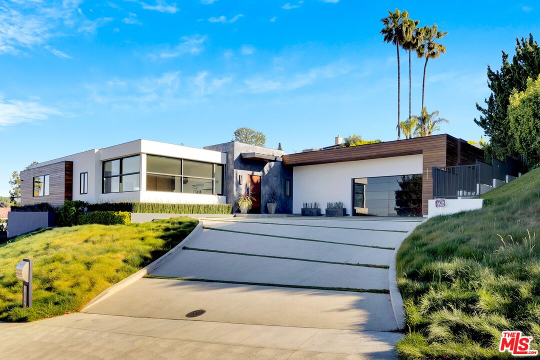 16366 Sloan Drive Los Angeles, CA 90049 - Photo 2 of 54 a front view of a house with garden