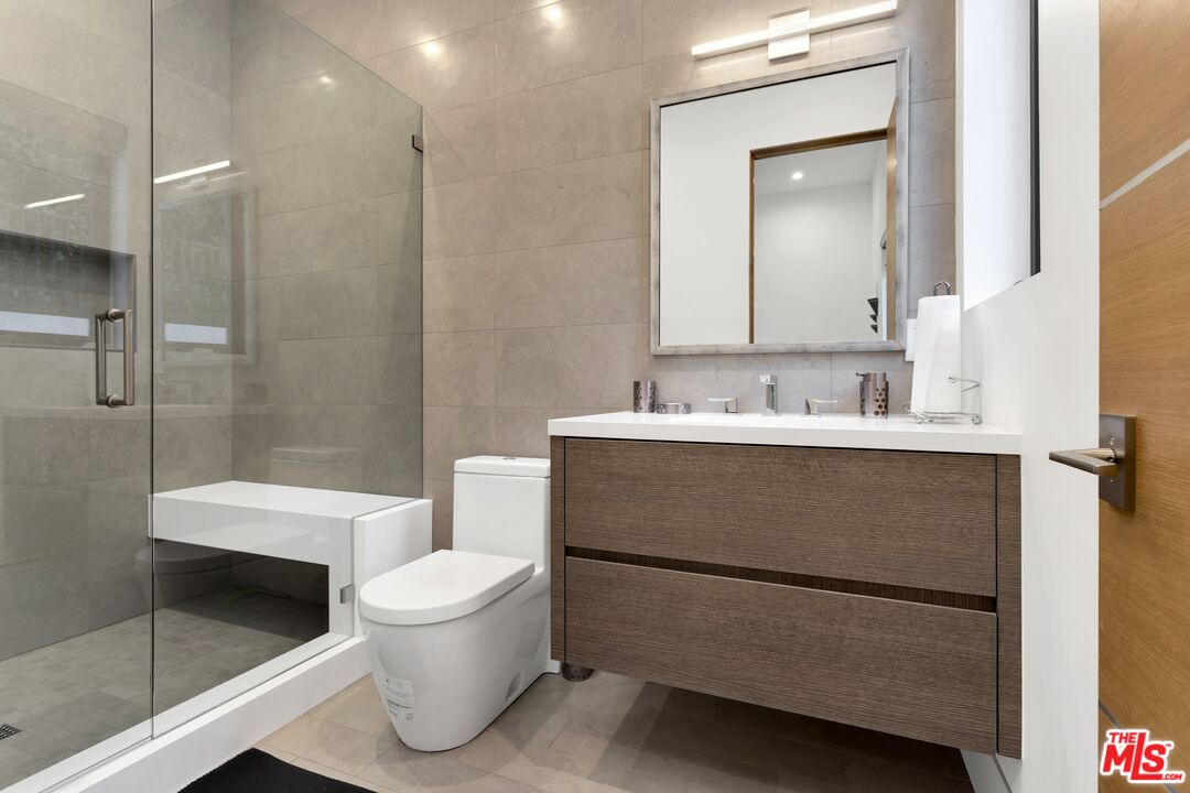 16366 Sloan Drive Los Angeles, CA 90049 - Photo 25 of 54 a bathroom with a sink toilet and shower