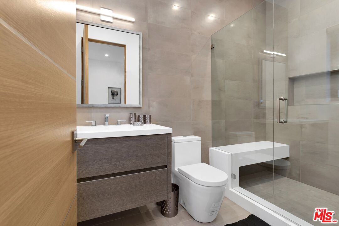 16366 Sloan Drive Los Angeles, CA 90049 - Photo 28 of 54 a bathroom with a sink a toilet and shower