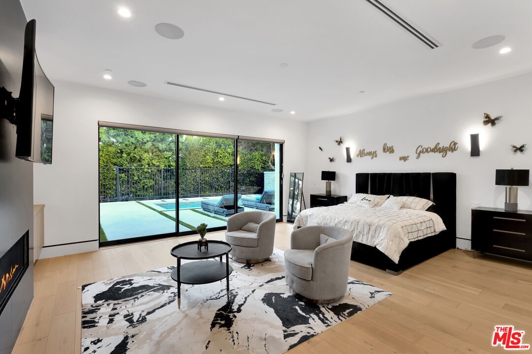 16366 Sloan Drive Los Angeles, CA 90049 - Photo 30 of 54 a living room with furniture and a large window