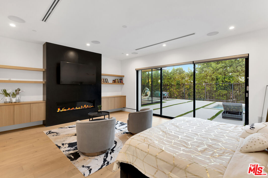 16366 Sloan Drive Los Angeles, CA 90049 - Photo 31 of 54 a bedroom with a bed and large window