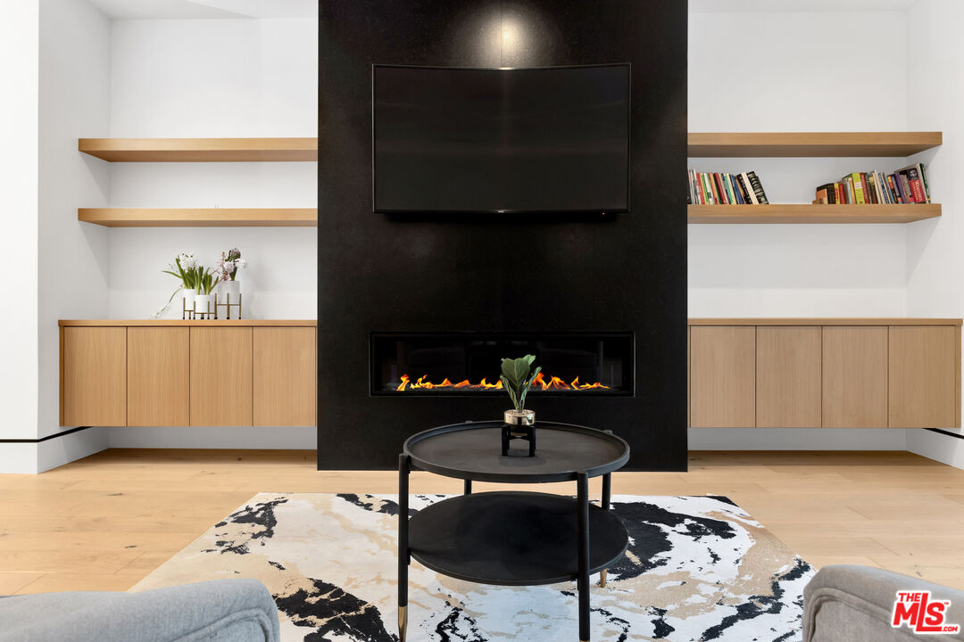 16366 Sloan Drive Los Angeles, CA 90049 - Photo 32 of 54 a living room with furniture and a fireplace