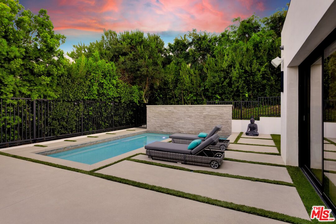 16366 Sloan Drive Los Angeles, CA 90049 - Photo 40 of 54 a view of a bench in front of building