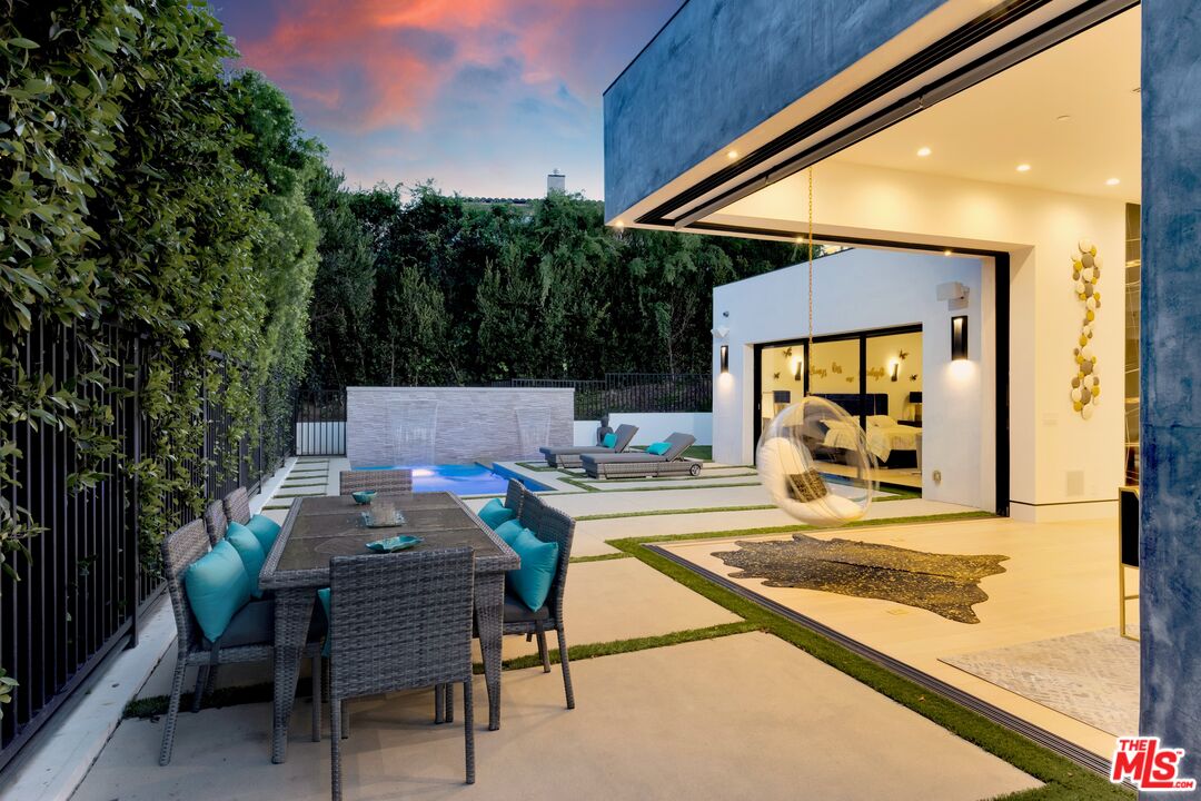 16366 Sloan Drive Los Angeles, CA 90049 - Photo 44 of 54 a view of house with backyard and sitting area