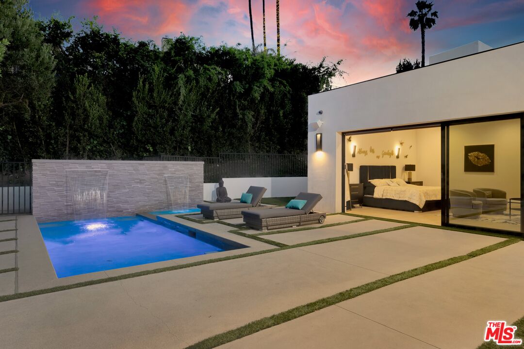 16366 Sloan Drive Los Angeles, CA 90049 - Photo 47 of 54 a view of swimming pool with seating area and trees in the background