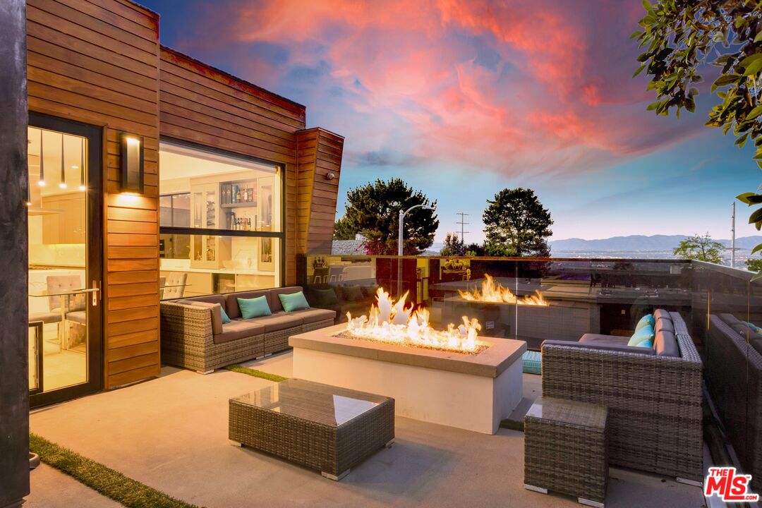 16366 Sloan Drive Los Angeles, CA 90049 - Photo 48 of 54 a living room with furniture and a flat screen tv