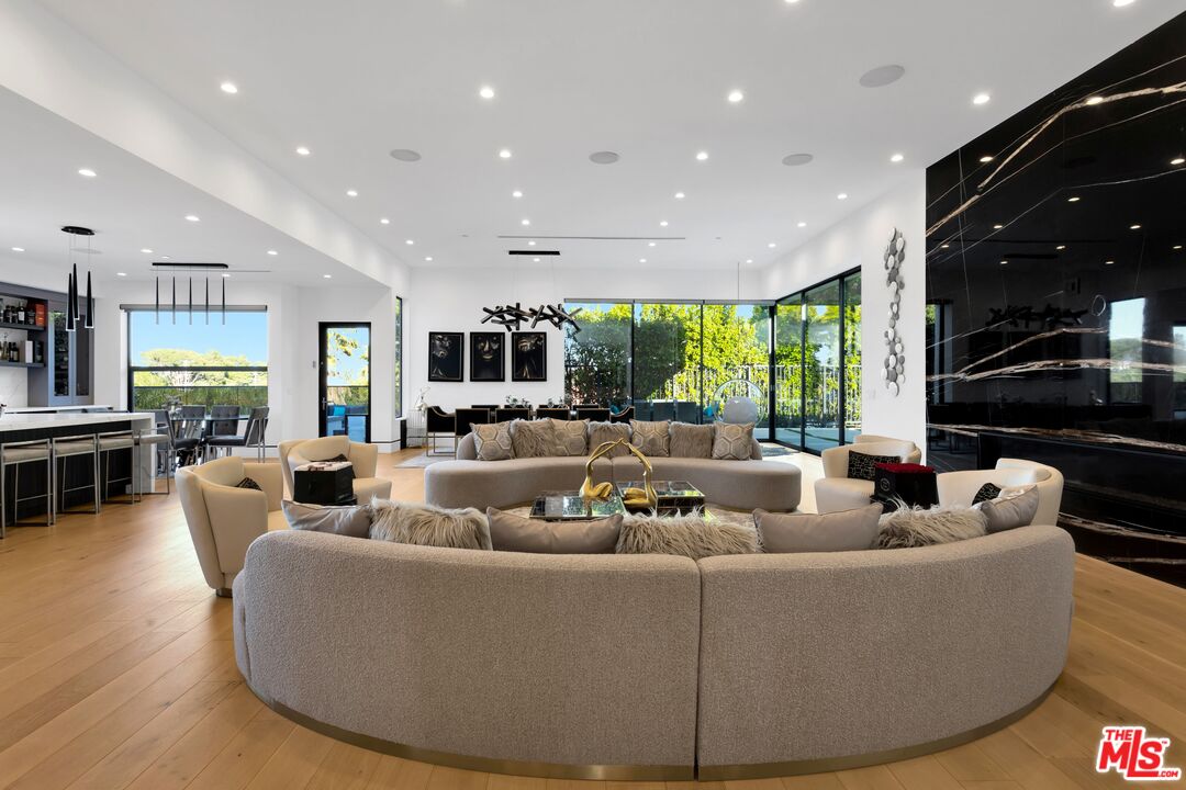 16366 Sloan Drive Los Angeles, CA 90049 - Photo 9 of 54 a living room with furniture and a large window
