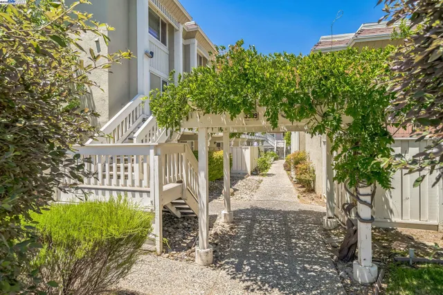 a view of a house with a tree in the background