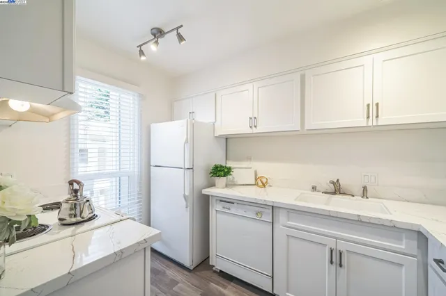 a kitchen with a sink cabinets and window