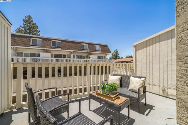 a view of a patio with a table and chairs