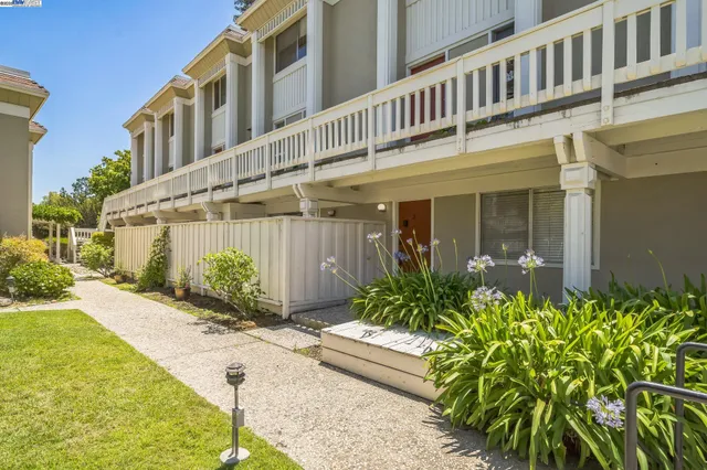 a front view of a building with a garden