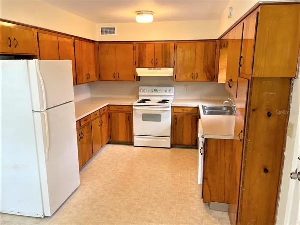 a kitchen with a refrigerator a stove a washer and dryer