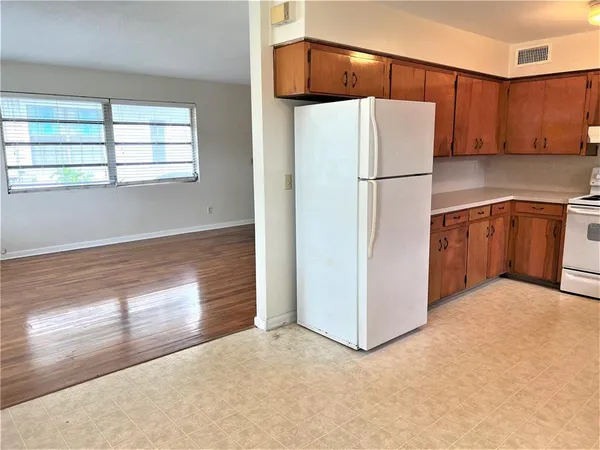 a kitchen with stainless steel appliances granite countertop a refrigerator and a stove