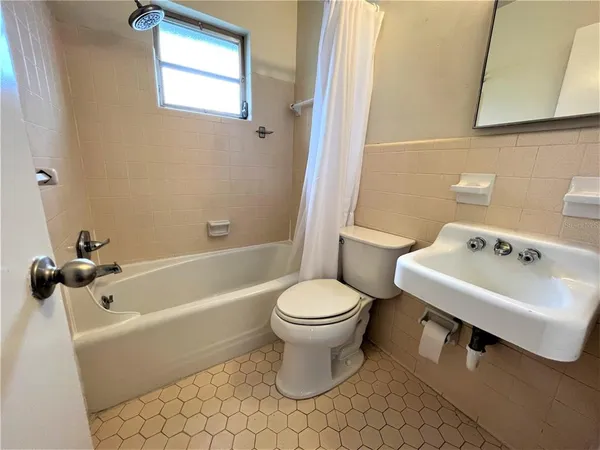 a bathroom with a sink toilet and bathtub