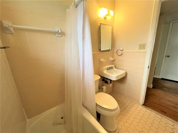 a bathroom with a toilet a sink and shower