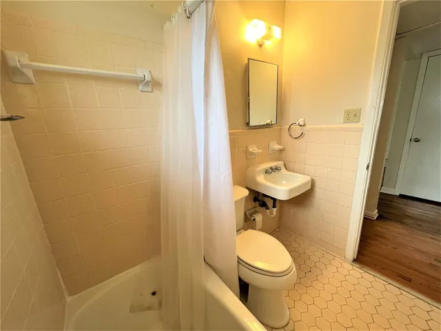 a bathroom with a toilet a sink and shower