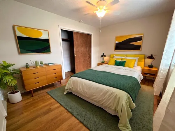 a bedroom with a bed and flat screen tv
