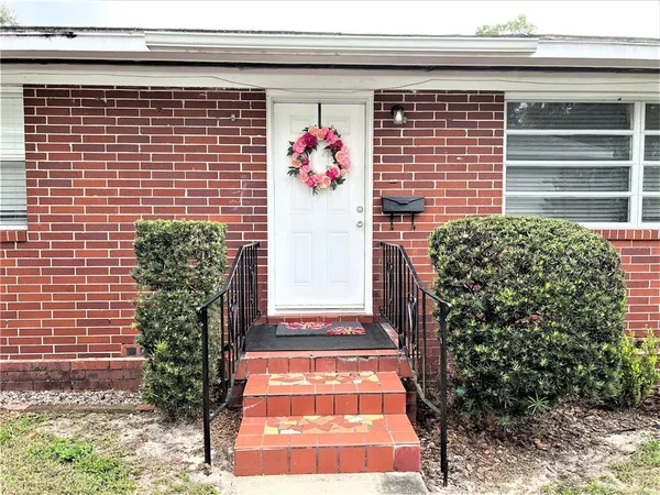 a view of a door and brick walls