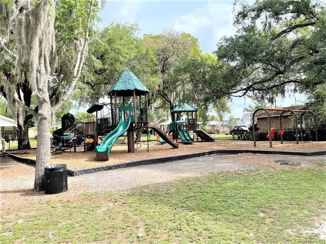 a view of a park with swings and slides
