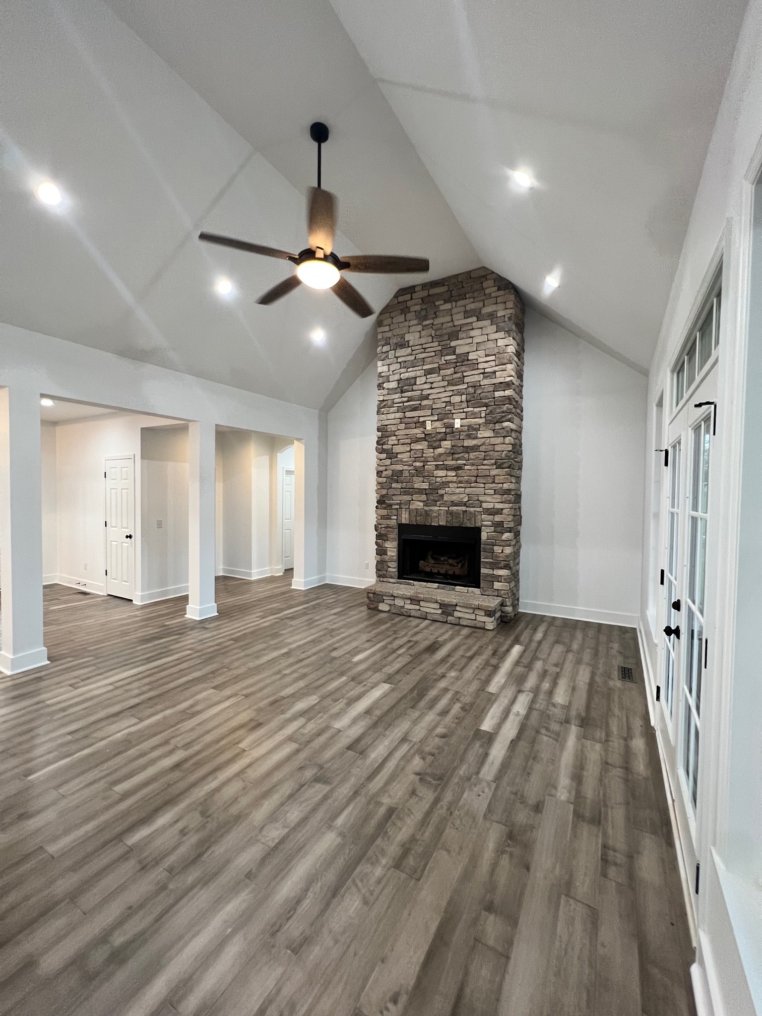 236 Buffalo Road Carthage, TN 37030 - Photo 3 of 55 an empty room with wooden floor fireplace and windows