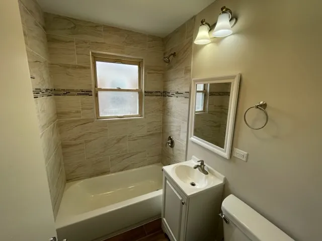 a bathroom with a sink mirror toilet and bathtub