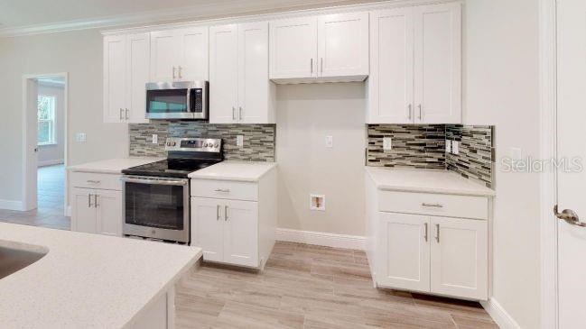 Tbd Mohawk Road Venice, FL 34293 - Photo 4 of 16 a kitchen with white cabinets and appliances