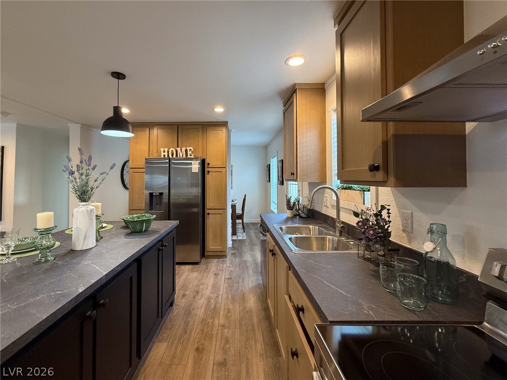 464 Box Canyon Road Alamo, NV 89001 - Photo 17 of 48 Rich wood cabinets and dark stone counters define this modern, fully equipped kitchen.