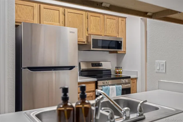 a kitchen with stainless steel appliances granite countertop a sink and a white cabinets