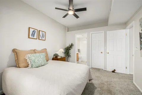 a bedroom with a bed a couch and a window