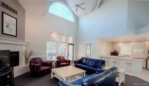 a living room with furniture and gym equipment