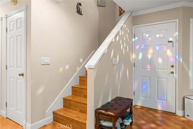 a view of entryway and hall with wooden floor